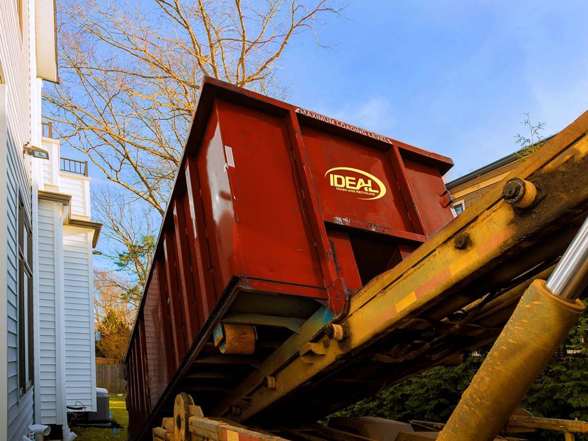 IDEAL dumpster being offloaded onto a yard